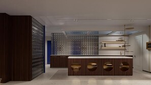 A modern kitchen with a central island, built-in cabinets, and a glass partition. - Hotel Leev Miromesnil (Paris)