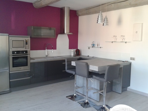 A modern kitchen with a built-in oven, microwave, and stainless steel appliances. - Holiday in the Sun and Sea, Apartment on 1st or 2nd floor! (Elne)