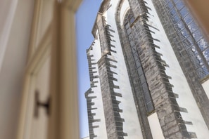 A view of a tall, narrow building with a pointed roof and a series of windows. - Youngmann House (Prague)