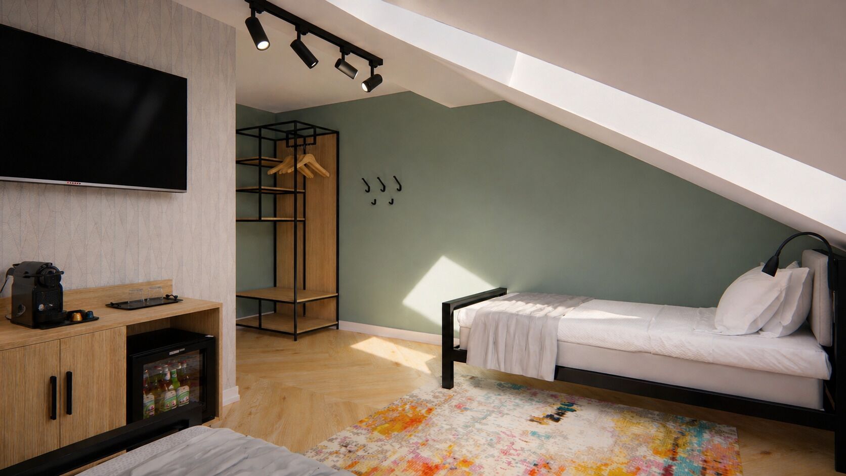 A bedroom with a bed, a TV, a coffee machine, and a wardrobe.