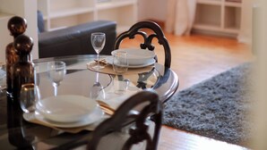 A dining area with a round table, chairs, and a television in the background. - Ponte Vecchio SPA & Lift (Firenze)