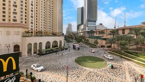 A city square with a McDonald's, a roundabout, and tall buildings in the background. - Sadaf 2701 (Dubai)