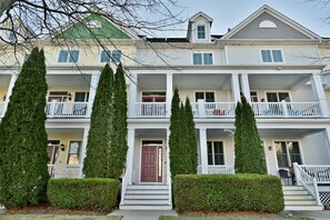 A multi-story building with a central entrance, balconies, and a symmetrical facade.