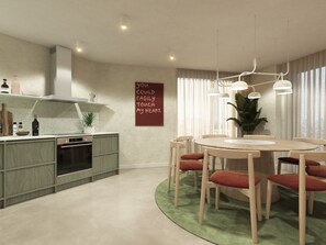 Una cocina moderna con comedor, que incluye una mesa redonda y sillas, una alfombra verde y un letrero en la pared.