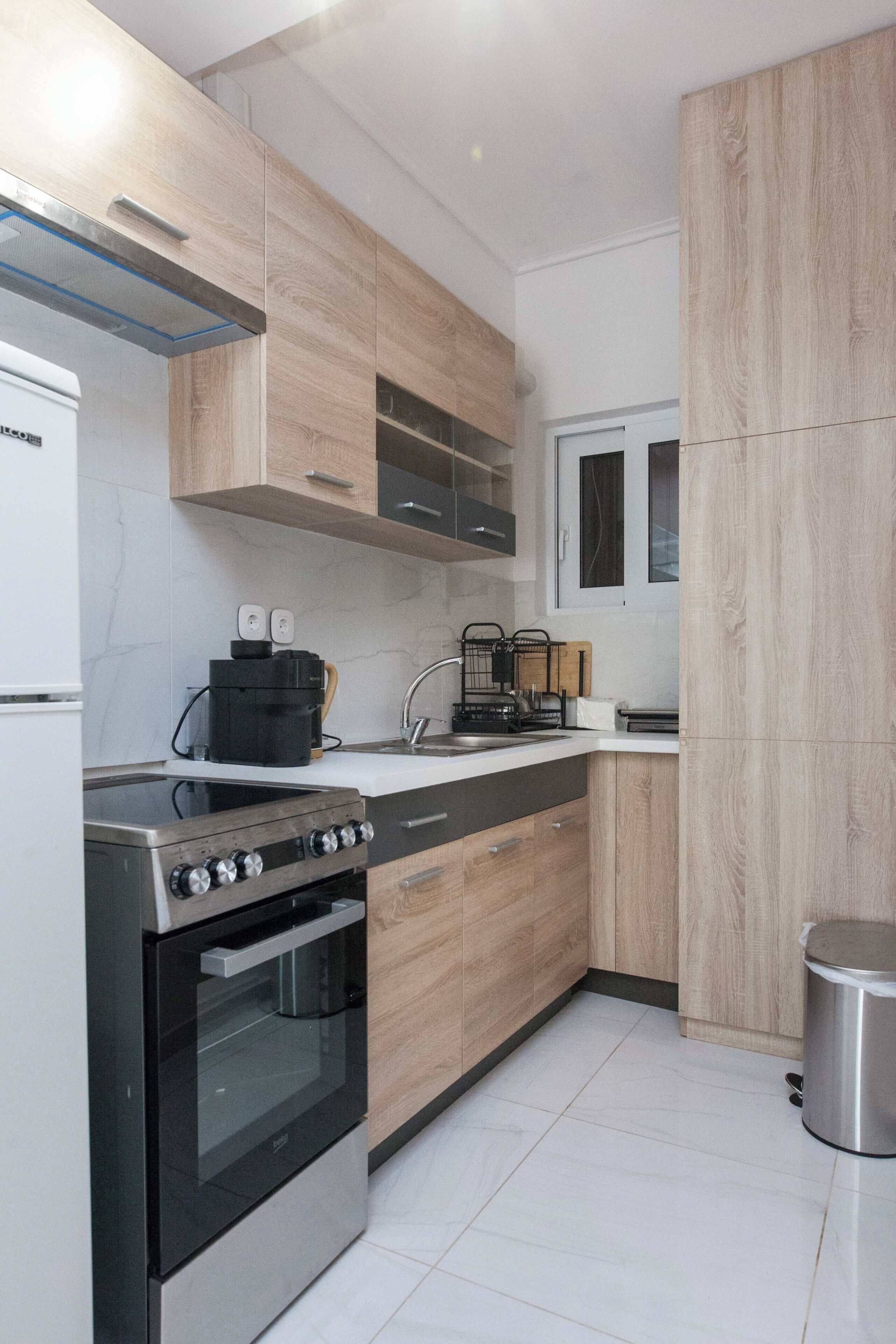 Een moderne keuken met een inbouwoven, een kookplaat en een spoelbak.
