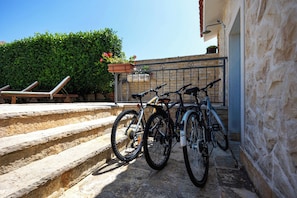 A stone staircase leading to a building with a metal railing. There are two bicycles parked against the railing. - Villa Peaceful Valley With Heated Pool (Sestanovac)