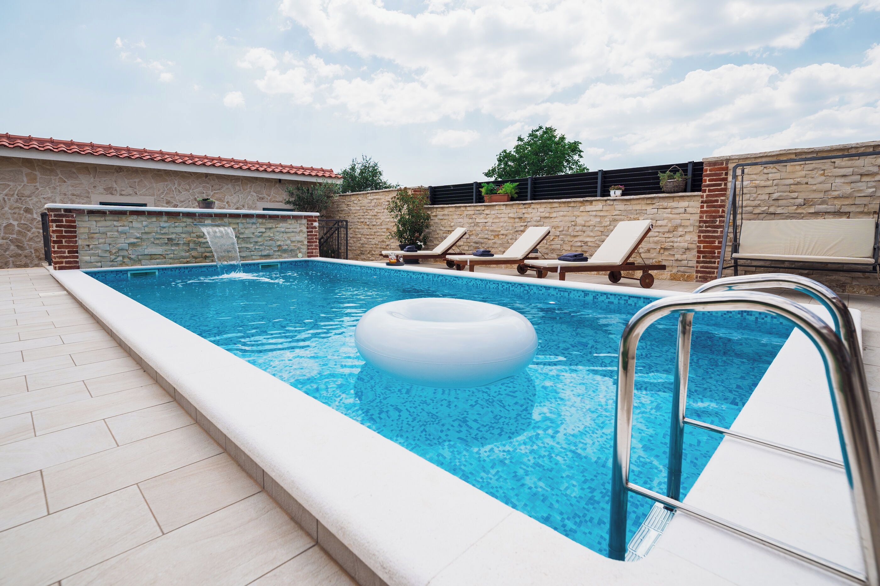 Outdoor pool, a heated pool, pool umbrellas