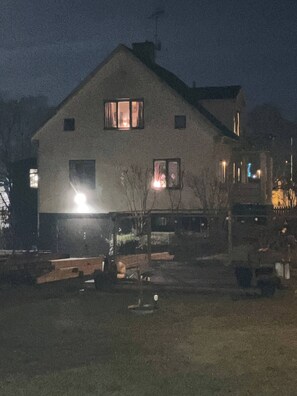 A two-story house with a sloped roof, multiple windows, and a visible chimney. - Large Family Housing (Mariannelund)