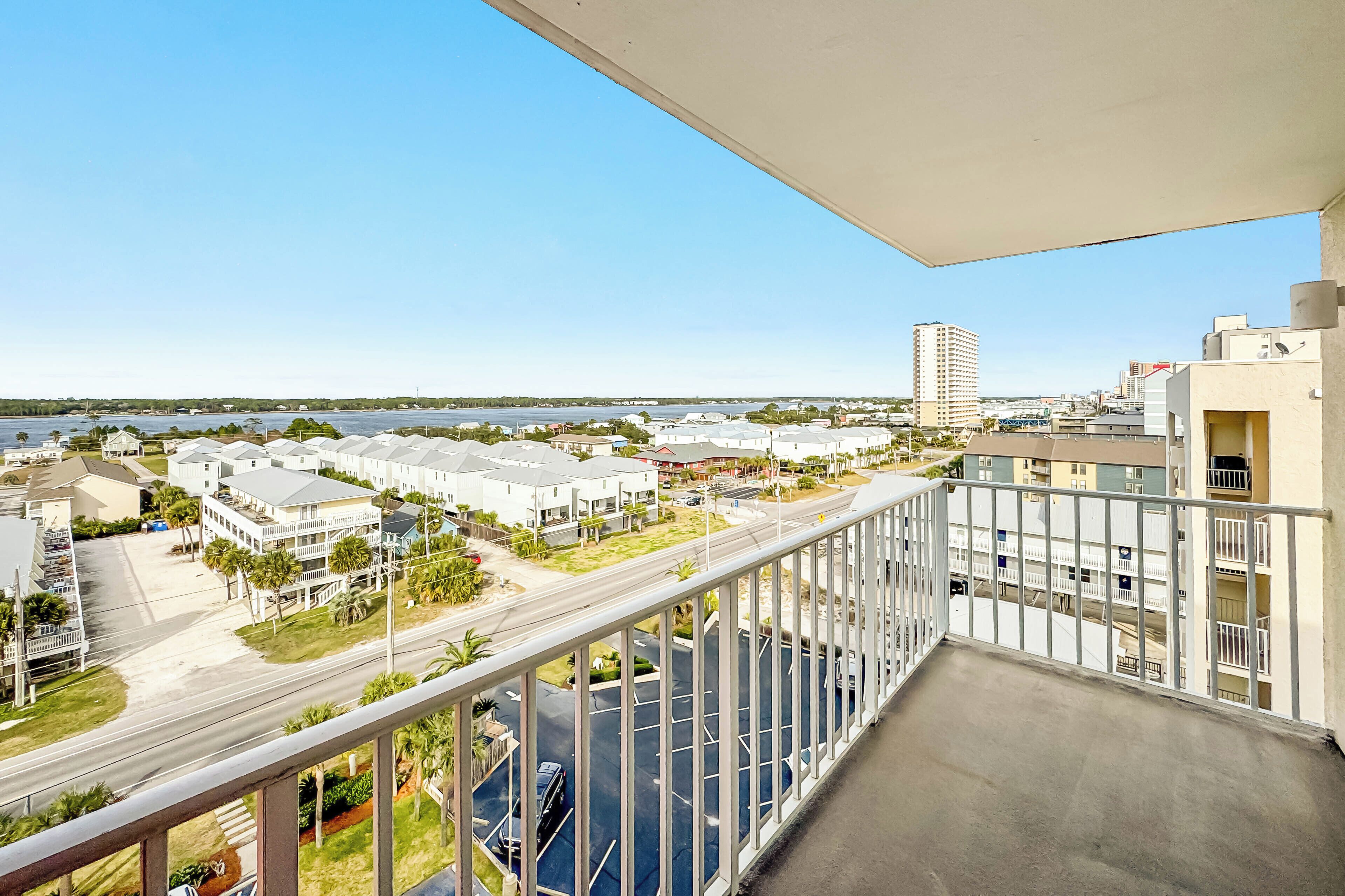 A balcony with a view of a marina and buildings.