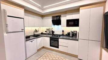 Family Suite, City View | Private kitchen | Coffee/tea maker, electric kettle, highchair