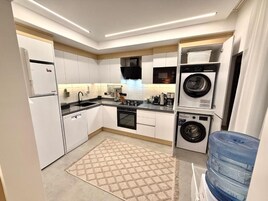 Family Suite, City View | Private kitchen | High chair