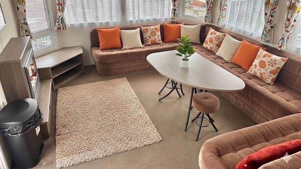 A cozy living area with a sofa set, a small table, and a rug. - Delta, Bromley 4-Bedroom Caravan (Uddingston)