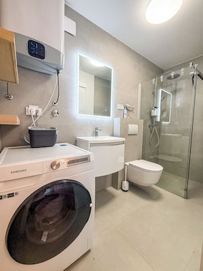 Shower, hair dryer, towels, toilet paper