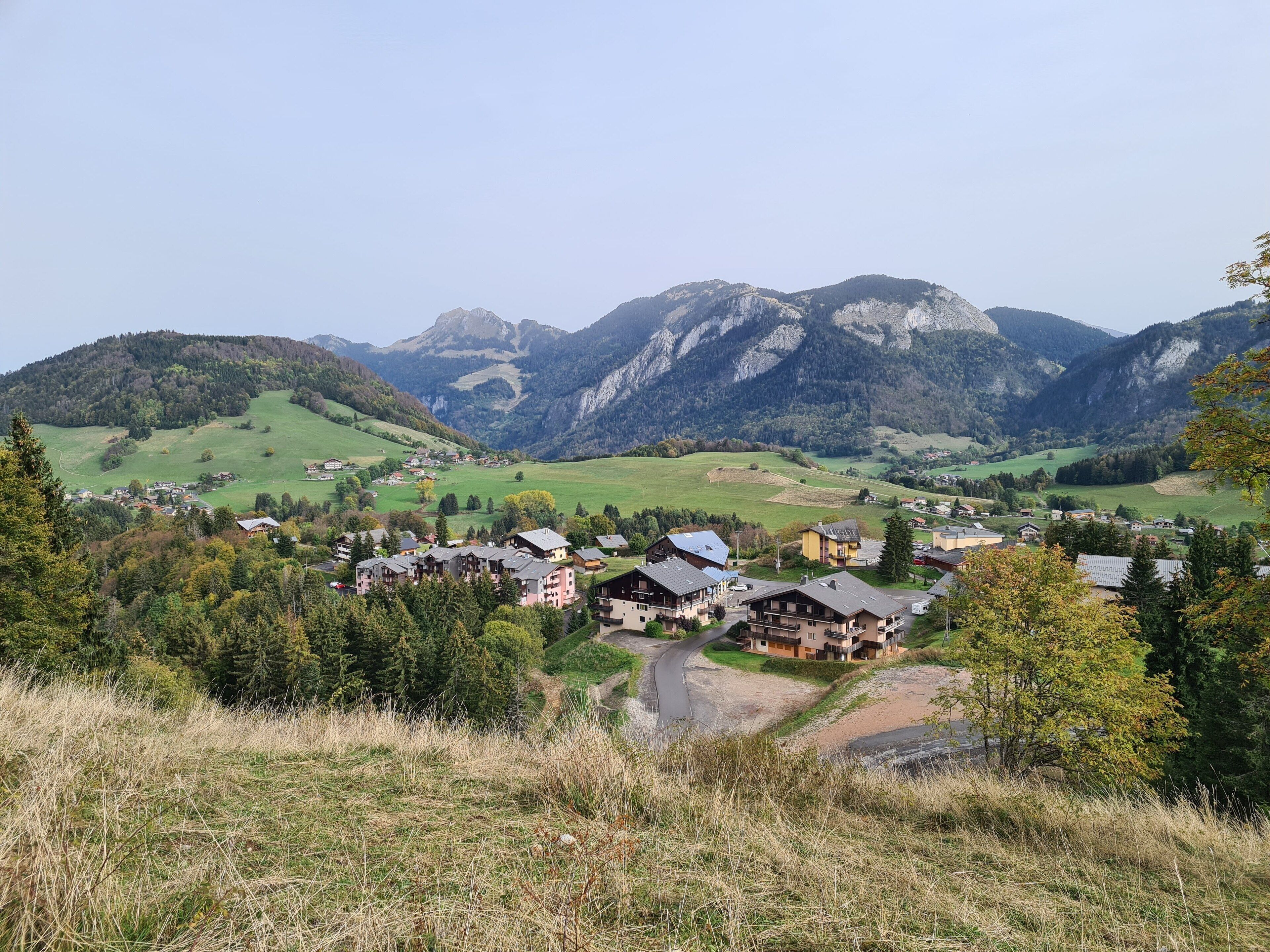 A mountainous landscape with a small village and houses.