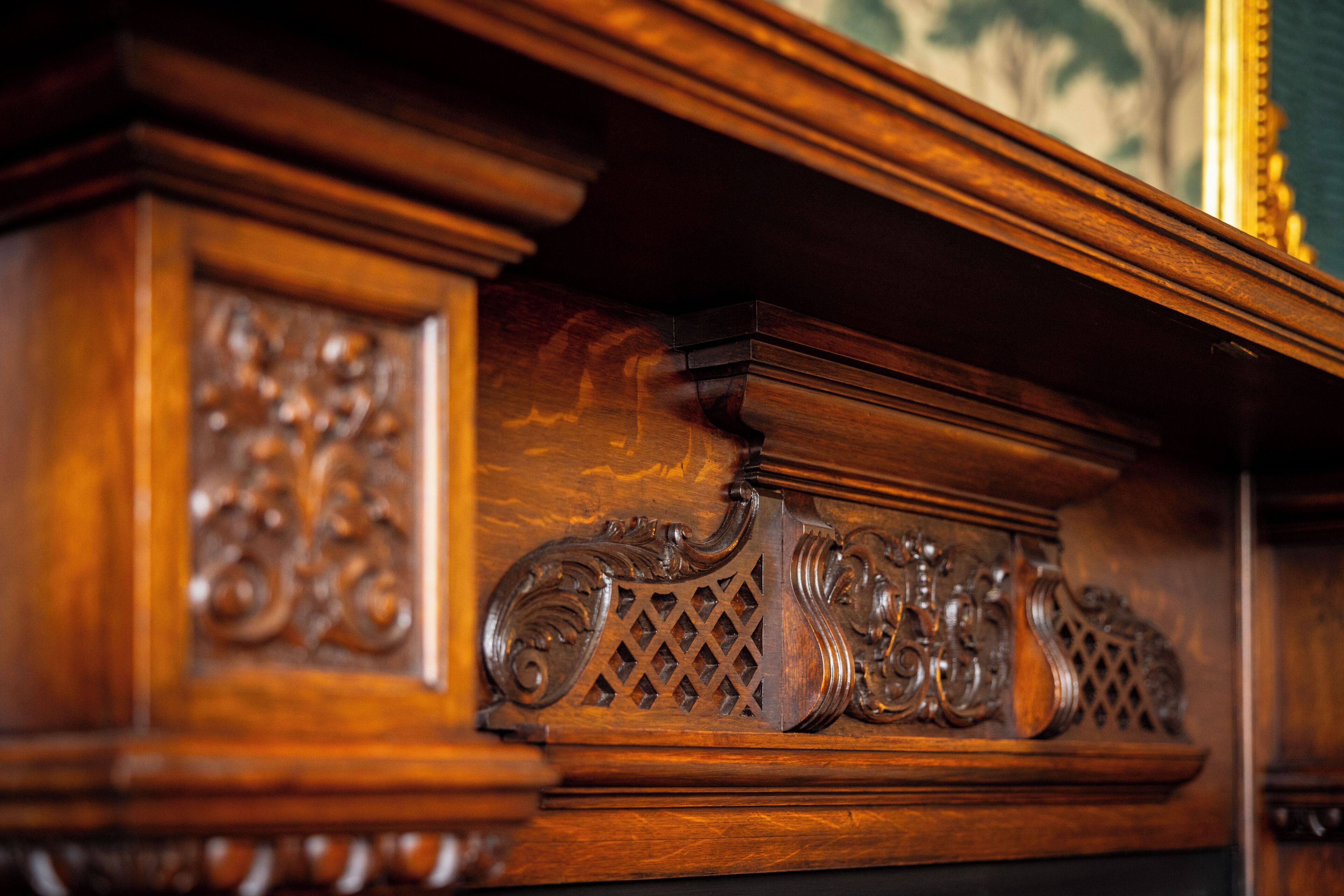 A close-up of a wooden carved detail, likely part of a piece of furniture or architectural feature.