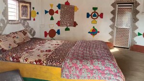 A room with a bed, a window, and decorative wall art. - Rann Roshni Homestay – Family Friendly Stay in Kutch 6 (Bhirandiara)