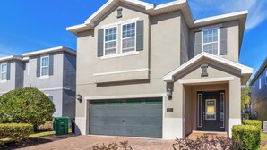 A modern two-story house with a garage, a front door, and a small porch. - 25% Off 8BR Villa! Pool/Spa.  Game & Movie Rooms (Davenport)