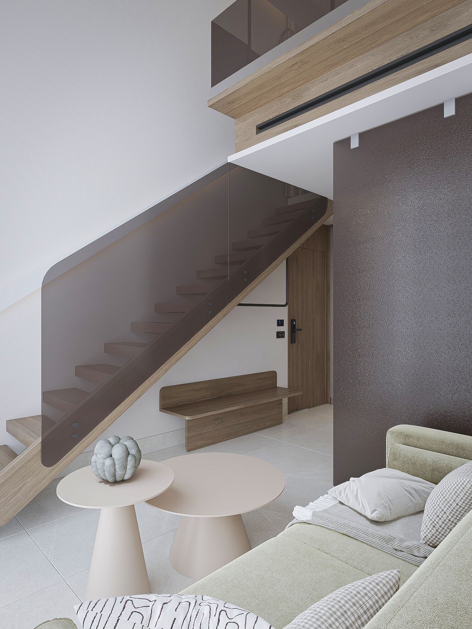 Um interior moderno com escada, sofá e mesa redonda.