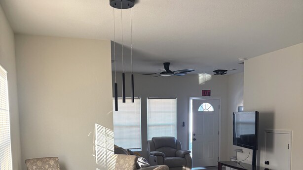 A spacious living room with a glass-top coffee table, beige patterned chairs, a sofa, and a television on a stand. - Cozy Modern Retreat, Peaceful Stay Near Everything (Portsmouth)