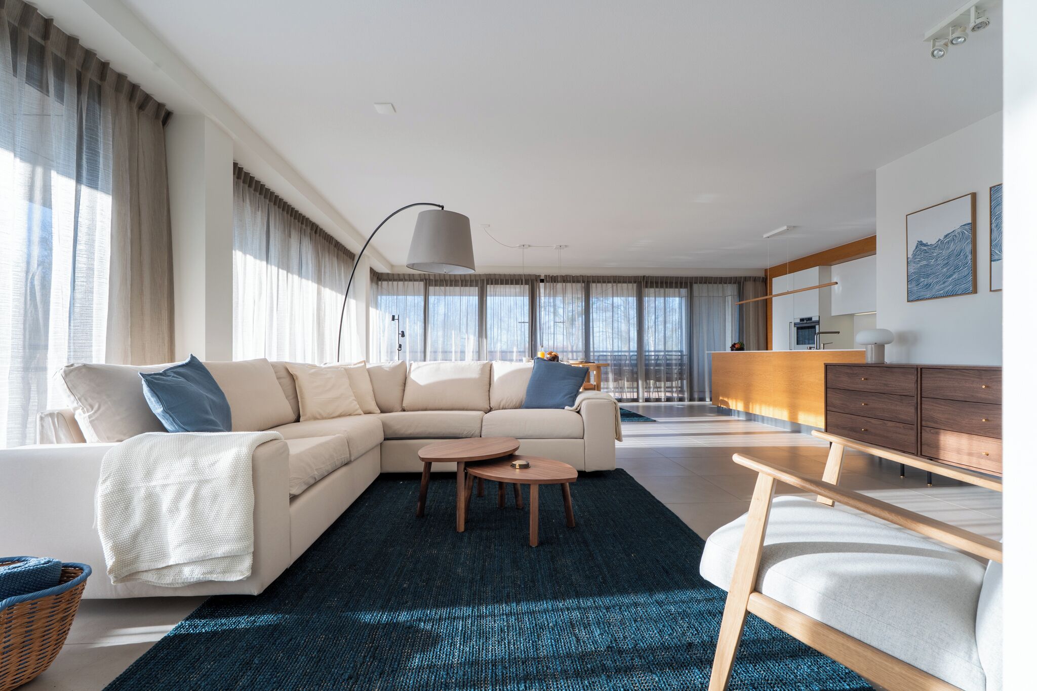 A modern living room with a sofa, coffee table, and a view of the city.