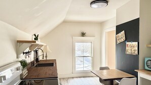 A kitchen with a wooden countertop, a stove, and a window. - Little Downtown Apt with Beautiful Window View (Brunswick)
