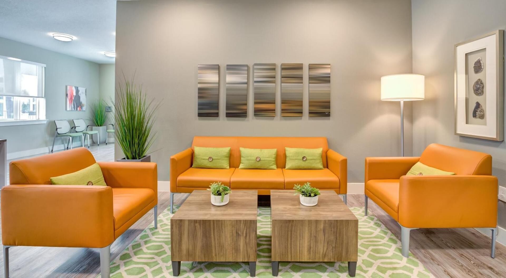 A modern living room with a sofa set, two coffee tables, and a floor lamp.