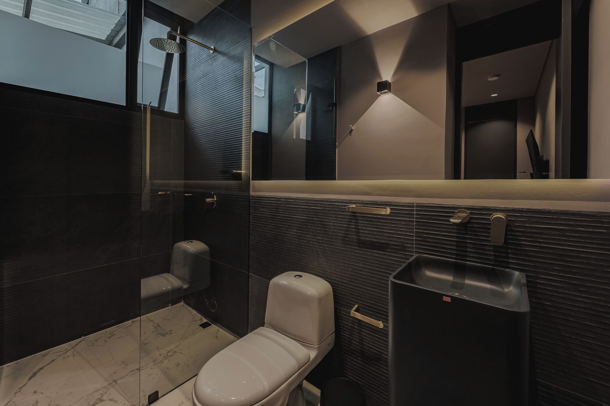 A modern bathroom with a toilet, bidet, and shower.