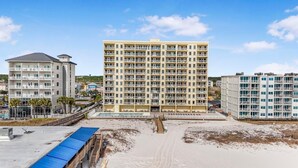 A multi-story hotel with balconies, a pool area, and a beach view. - Boardwalk 387 (Gulf Shores)