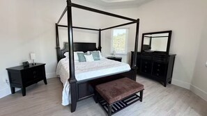 A four-poster bed with a bench, a dresser, and a nightstand in a bedroom. - Welcome to Casa Hibiscus, your private tropical escape in Miami! 4-bd, 4-baths (Miami)