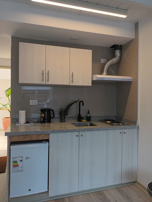 Fridge, coffee/tea maker, electric kettle, cookware/dishes/utensils