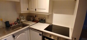 A compact kitchen with a dishwasher, a toaster, and a stove. - Modern Central 1BDR At St Stephen Green (Dublin 2)