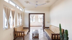 A spacious room with a high ceiling, a ceiling fan, and a view through an open door. - King beds, Starlink, Ocean Views, Steps to beach. (Puerto escondido Oaxaca)