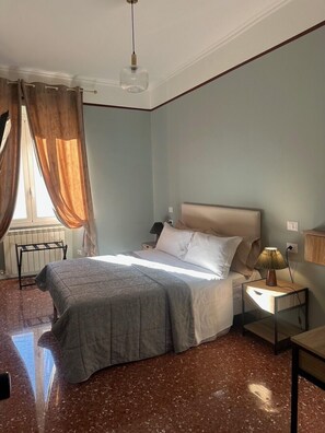 A bedroom with a bed, a nightstand, a lamp, and a window with curtains. - Guest House Chateau Indipendenza (Rome)