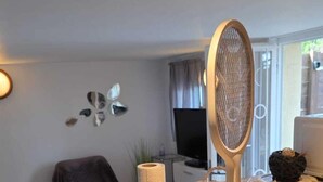 A kitchen counter with a smartphone, a bowl of food, a paper towel roll, and a microwave. - Quiet studio with optional access to a shared pool (La Ferté-Gaucher)