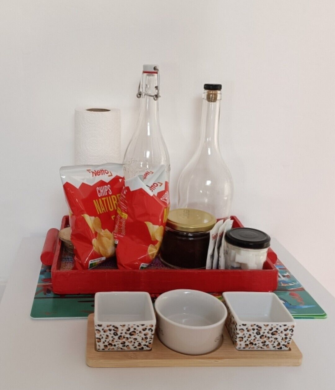 Een dienblad met snacks, sauzen en kleine schaaltjes op een tafel.