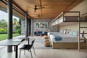 A modern bedroom with a bunk bed, a sofa, and a dining area with a table and chairs. - Casa Tukipa: 4BR High-End Villa w/ Private Pool (Punta Mita)