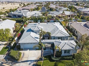 A residential area with multiple houses, each with a sloped roof and surrounded by greenery. - Gated Rancho Mirage Oasis w/ Pool & Spa (Rancho Mirage)