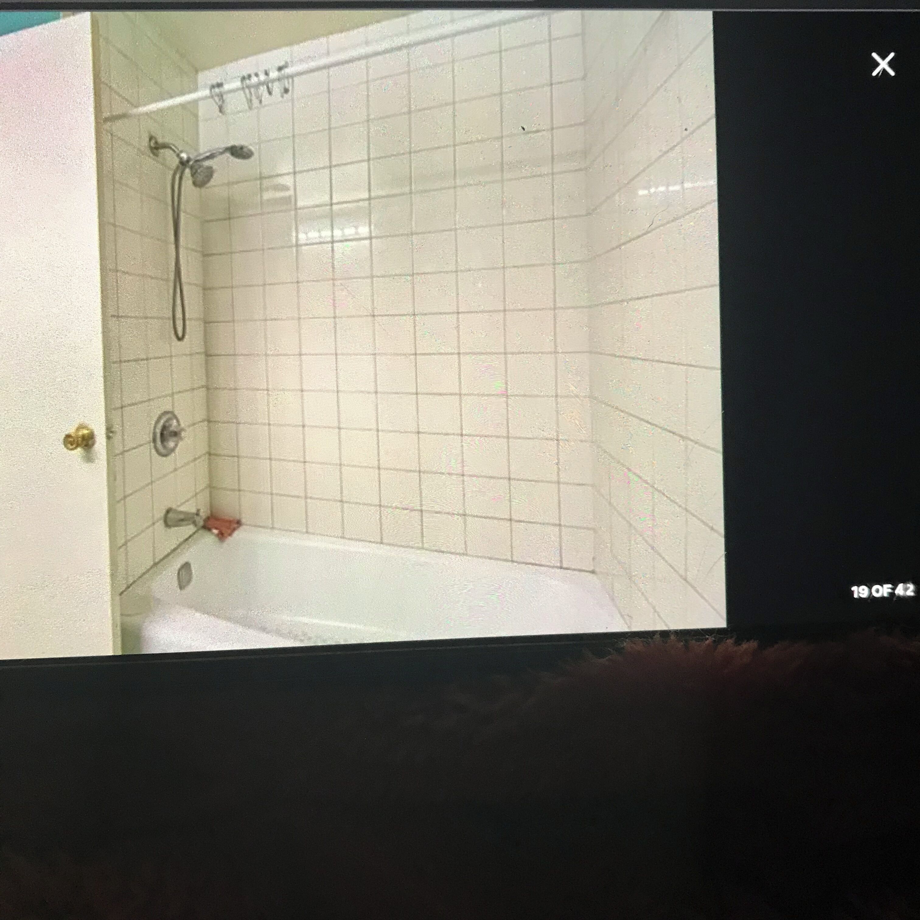 A bathroom with a bathtub, a shower, and a toilet.