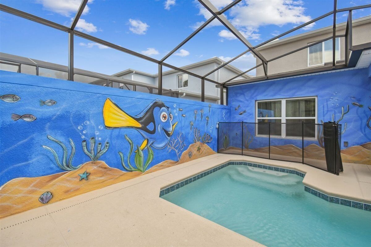 An indoor swimming pool with a mural of an underwater scene on the walls.