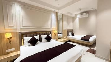 A hotel room with a large bed, a bedside lamp, a mirror, and a ceiling fan.
