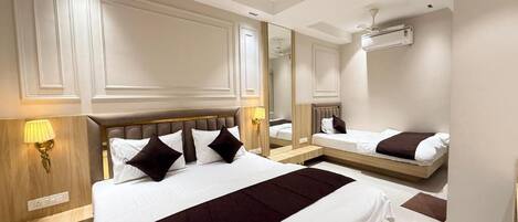 Deluxe Triple Room, City View | In-room safe, desk, laptop workspace, blackout drapes