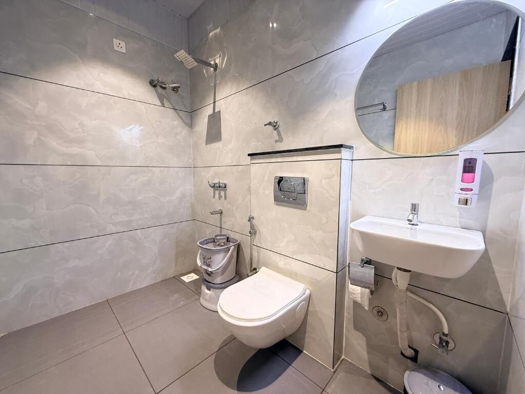 A modern bathroom with a toilet, bidet, and sink.