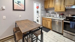 A compact kitchen with wooden cabinets, a stainless steel oven, a dishwasher, and a washing machine. - Relaxing Canyons Condo Free Shuttle Ride To Lift (Park City)