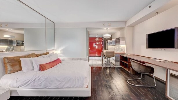 A modern hotel room with a large bed, a desk, a chair, and a television. - High Floor Mountain-views Studio Balcony Access (Las Vegas)