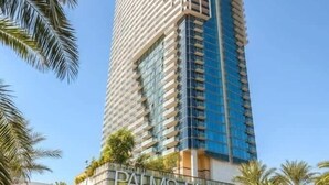 A tall hotel with a modern design, featuring a prominent 'PALMS PLACE' sign at the base. - Luxurious Sub-penthouse Studio Balcony Access (Las Vegas)