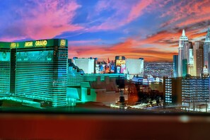 A cityscape with the MGM Grand hotel prominently featuring a large sign and a distinctive architectural design. - Kintsugi Retreat-condo-balcony-stripview (Las Vegas)