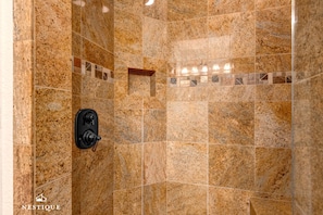 A shower area with granite tiles and a small shelf. - Westgate 4916-b (Park City)