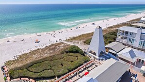A beachside hotel with a prominent pyramid-shaped structure, a sandy beach, and a view of the ocean. - Four by the Shore (Santa Rosa Beach)