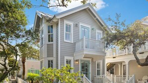 A two-story house with a balcony, a covered porch, and a barbecue grill. - Little Dipper (Santa Rosa Beach)