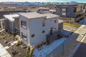 A modern multi-story residential building with a flat roof, large windows, and a small front porch. - Luxury Escape - Silver Creek (Park City)